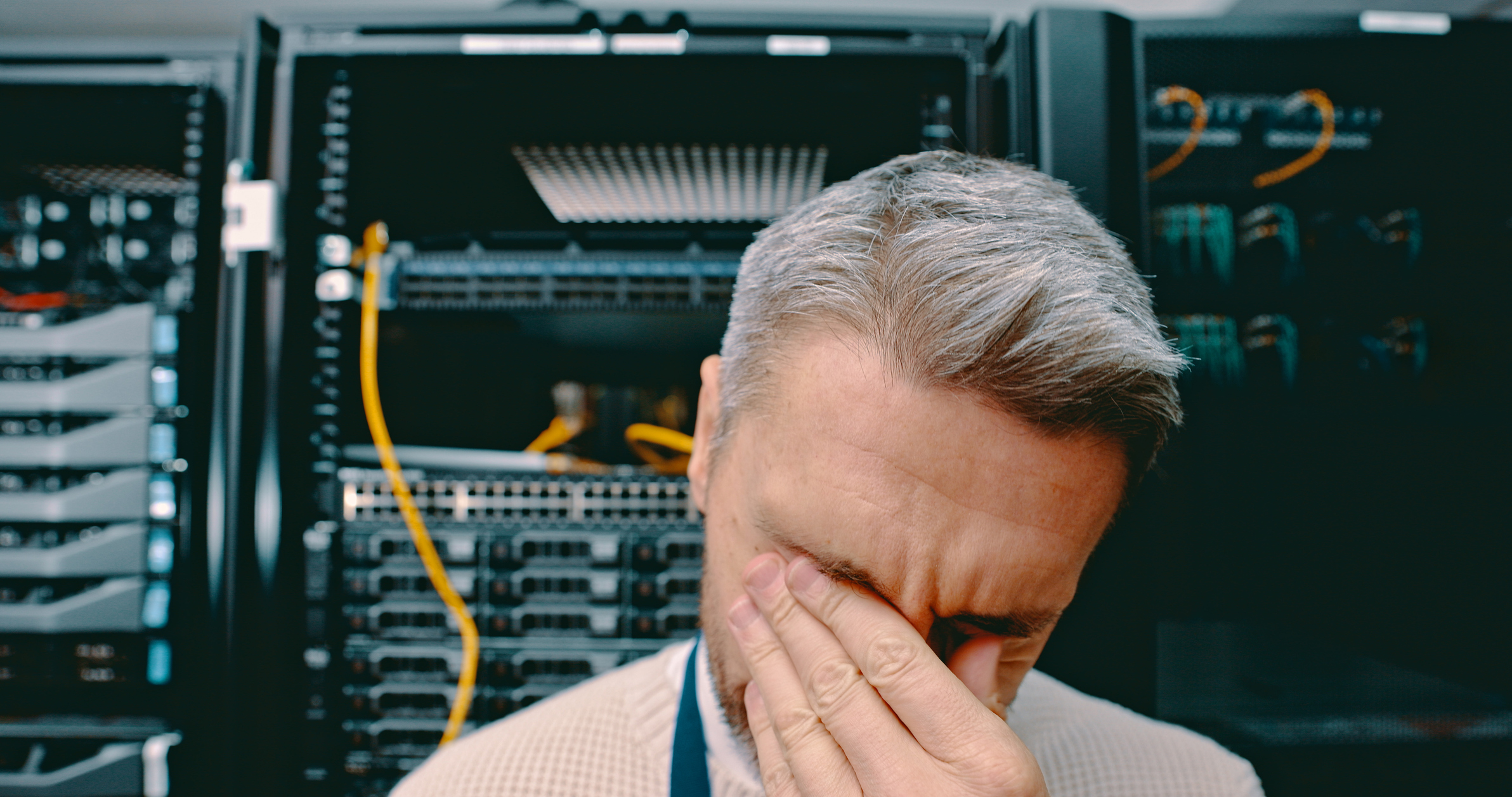 Shot of a technician experiencing a headache while at work